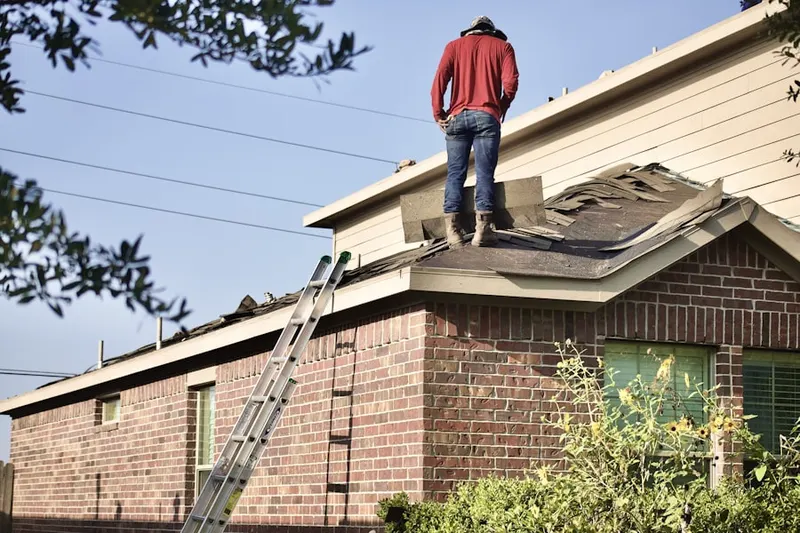 Professional roofer working on a residential roof in Brewer